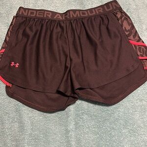 Black under armour shorts with orange and grey detail. Size large, loose.